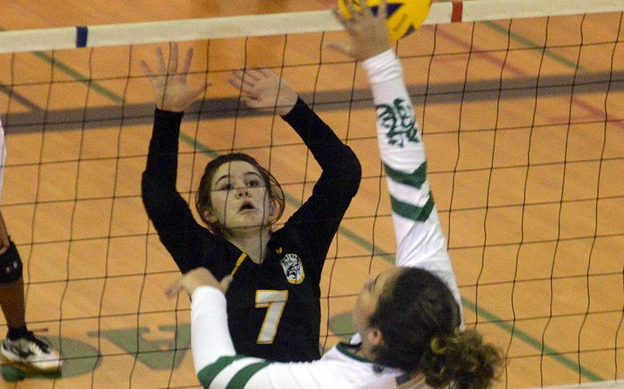 Kubasaki's Mackinzi Dudley spikes against Kadena's Deniz Dussetschleger during Thursday's Okinawa girls volleyball match. The Dragons won in three sets.