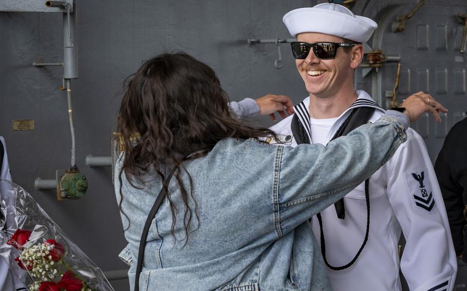 A sailor embraces his wife