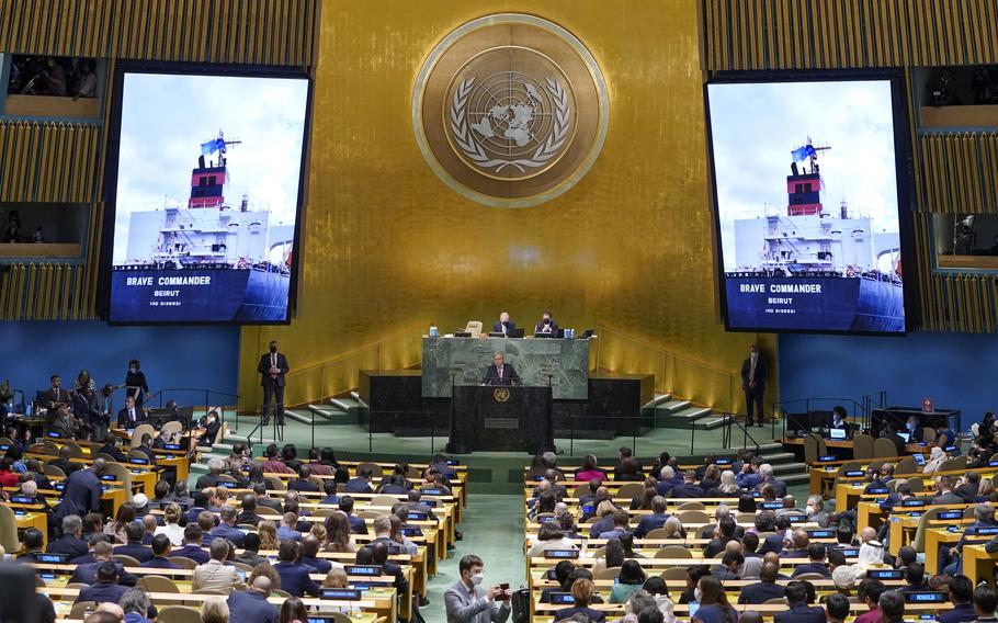 An image of the 'Brave Commander' ship carrying grain from Ukraine is displayed on screens as Secretary-General António Guterres addresses the 77th session of the General Assembly at United Nations headquarters Tuesday, Sept. 20, 2022. 