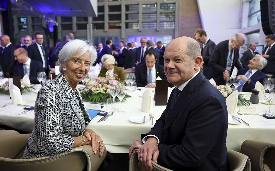 European Central Bank president Christine Lagarde, left, and German Chancellor Olaf Scholz sit at a table during a ceremony to celebrate the 25th anniversary of the European Central Bank, in Frankfurt, Germany, Wednesday May 24, 2023.