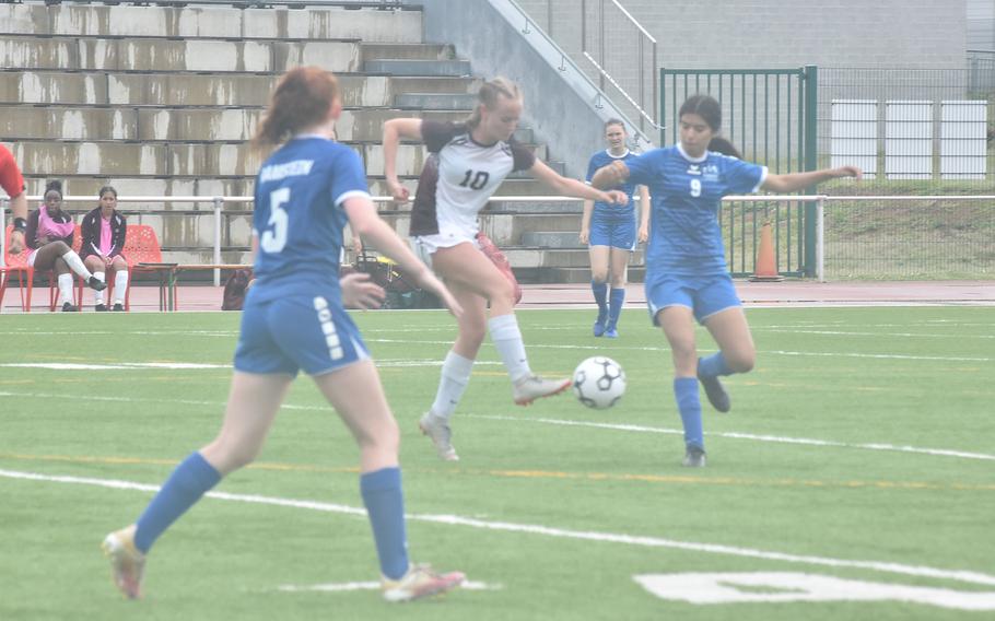 Villseck's Brennia Waters tries to control the ball Monday, May 16, 2022, while Ramstein's Angely Atkinson, right, and Gabriella Clark approach at the DODEA-Europe girls Division I soccer championships at Vogelweh, Germany.