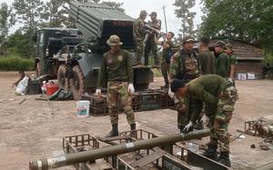 Several Cambodian service men operate a missile launcher.