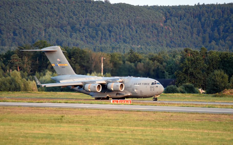 A U.S. Air Force C-17 aircraft carrying evacuees from Afghanistan lands at Ramstein Air Base, Germany, on Friday, Aug. 20, 2021.