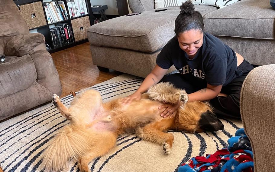 Rachel Pierre plays with Bear, the Ohana Meals host family dog, in this undated photograph taken at Marine Corps Air Station Iwakuni, Japan. 