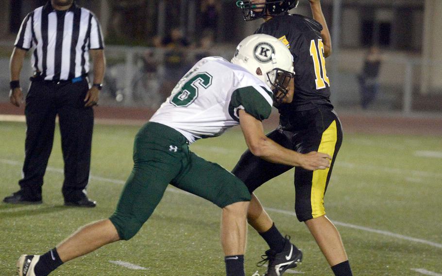 Kubasaki defensive end Ian Lyons tries to bring down Kadena quarterback Braxton Reece.