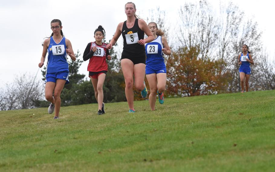 Stuttgart’s Sydney Lamphier leads a pack of runners down a hill at the DODEA-Europe cross country championships on Saturday, Oct. 23, 2021, in Baumholder, Germany. Lamphier finished second.