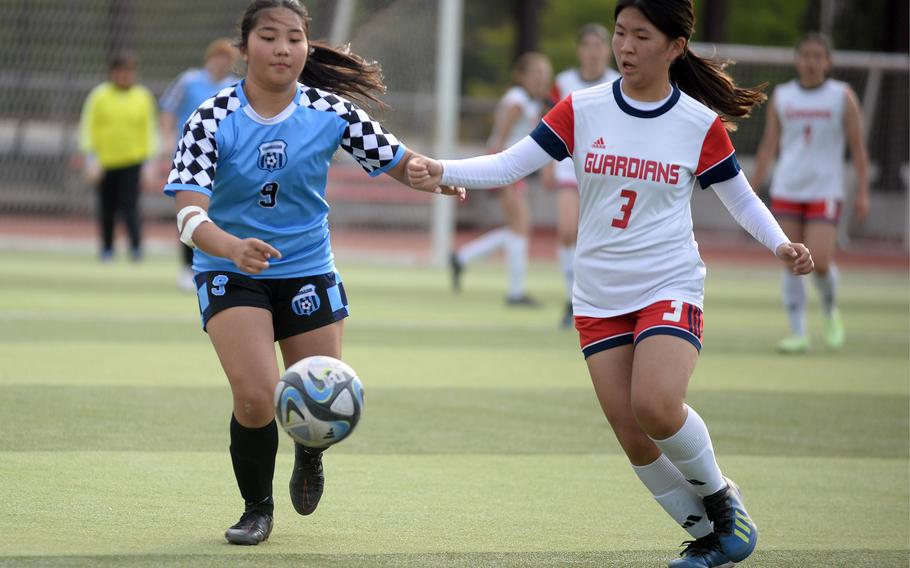 Osan's Clarice Lee and Yongsan International-Seoul's Zoe Chung chase the ball during Friday's Korea girls soccer match. The Guardians won 2-1.