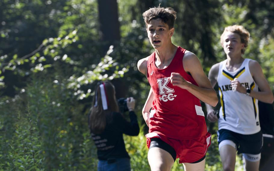 Brandon Maul, a runner at Kaiserslautern, overtakes another competitor during the final stretch of a high school boys’ varsity cross country race Saturday, Sept. 18, 2021, in Kaiserslautern, Germany.