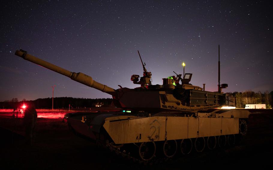 An M1A2 Abrams Tank from the 1st Armored Brigade Combat Team, 1st Infantry Division operates during a night gunnery exercise at Konotop Range, Drawsko Pomorskie, Poland, Jan. 28, 2022. The unit's deployment to Europe has been extended, Army officials said.
