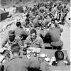 Hed: Bit of a picnic, 1955

Somewhere in South Korea, April 1955: Personnel of the 24th Recon, Co. in Korea eat lunch on tables outside their Quonset hut mess hall while the building gets a spring cleaning. “It’s almost like a picnic,” one of the 24th Div. soldiers cracked as he looked up at a warming April sun. Their squad tent quarters appear left background. 

Looking for Stars and Stripes’ historic coverage? Subscribe to Stars and Stripes’ historic newspaper archive! We have digitized our 1948-1999 European and Pacific editions, as well as several of our WWII editions and made them available online through https://starsandstripes.newspaperarchive.com/

META TAGS: Pacific; South Korea; U.S. Army; 24th Reconnaissance Company; 24th Infantry Division; military life; mess hall; food service