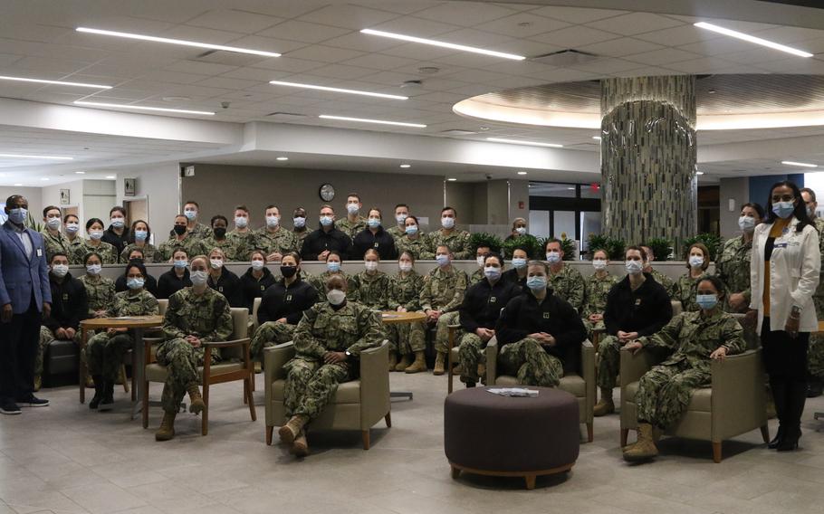 A U.S. Navy medical team joins together with Christian Hospital staff after being welcomed to the hospital to support COVID response operations in St. Louis, Jan. 29, 2022. The team ended its mission Wednesday as COVID admissions tumbled past a key threshold.