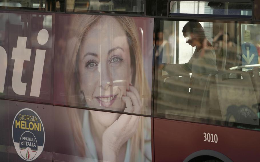 A poster of Italian politician Giorgia Meloni adorns the side of a bus in Rome, Friday, Sept. 16, 2022. Italy could be on the verge of electing its first woman premier.
