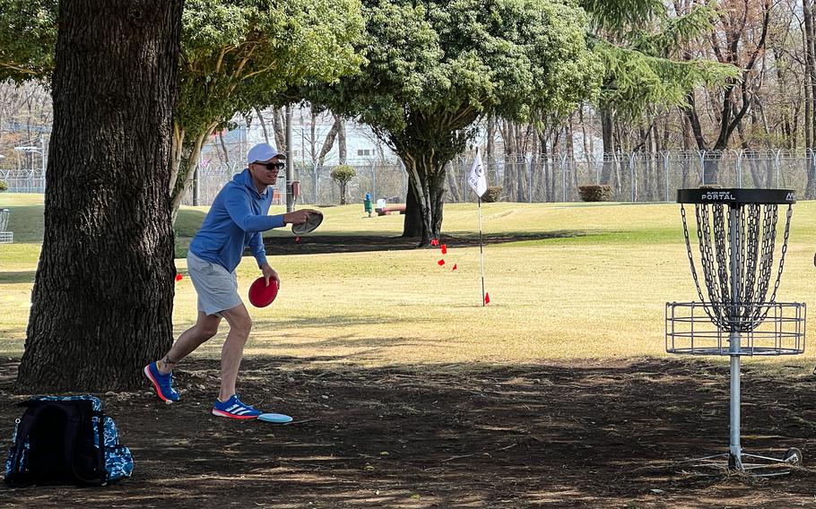 A man throwing a golf disc.