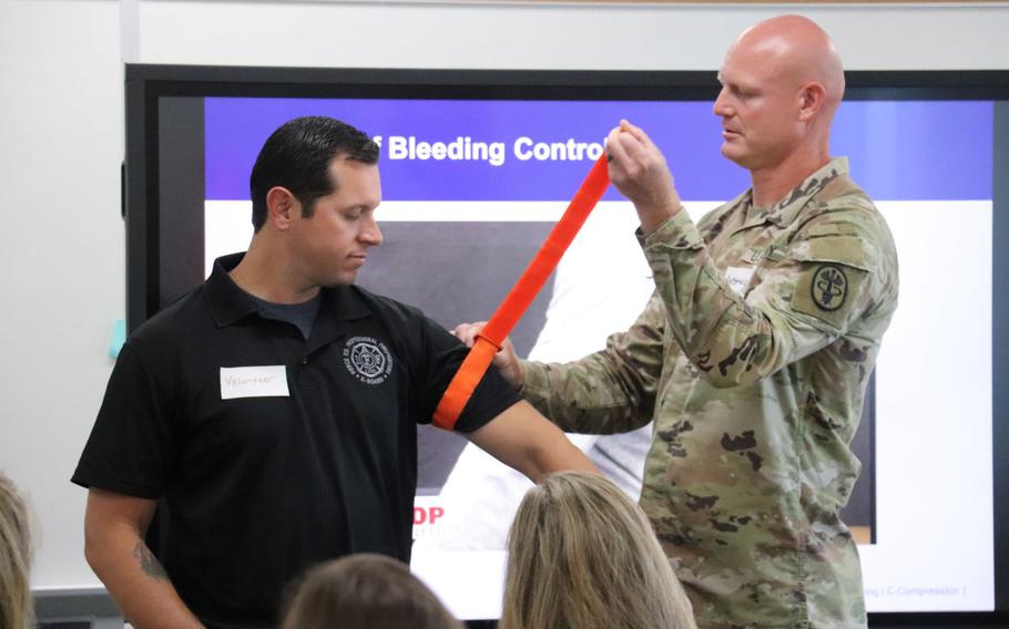 Dr. Quinton Hatch, general surgery program director at Madigan Army Medical Center at Joint Base Lewis-McChord, Wash., demonstrations how to use a tourniquet during a course on traumatic injury care to health professionals with Peninsula School District. The course is part of a Defense Department-supported program called Stop the Bleed, which teaches civilians lessons on trauma care the military has developed for troops in combat zones. 