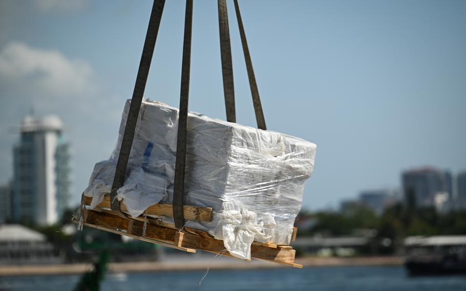 Bales of illegal drugs are offloaded