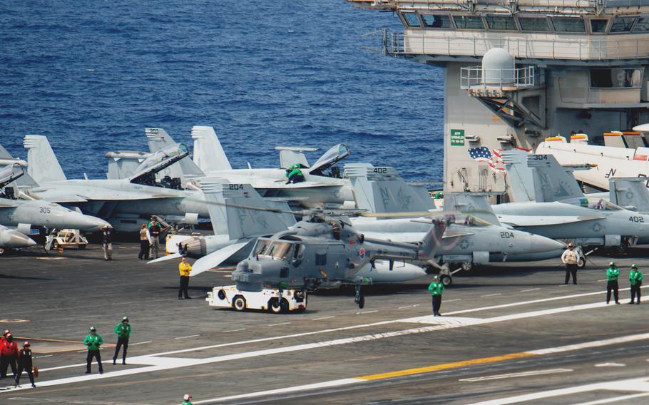 A South Korean navy helicopter lands on the aircraft carrier USS Ronald Reagan in the Philippine Sea on June 2, 2022.