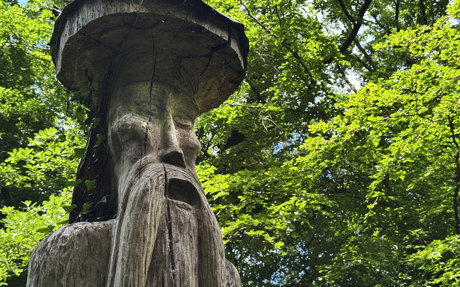 A wooden druid carved from a tree trunk.