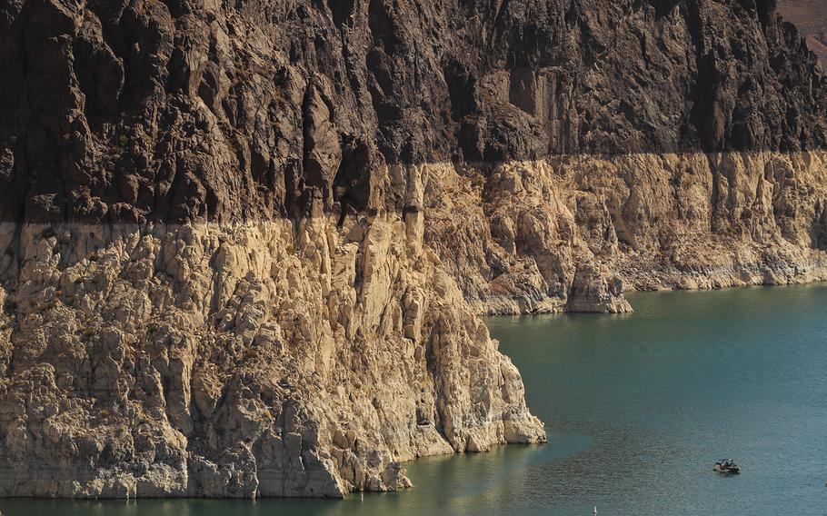 A boater gets an up-close view of the “bathtub ring” on Lake Mead — evidence of its low water level — while touring Hoover Dam. 