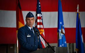 Col. Leslie Hauck, the outgoing commander of the 52nd Fighter Wing, addresses local officials during the change of command ceremony at Spangdahlem Air Base, Germany. Hauck received a certificate of recognition for his help during a disastrous flood in 2021.