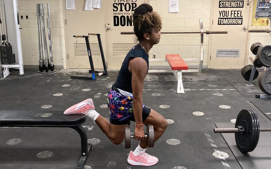Maurice Brown squats in the weight room.