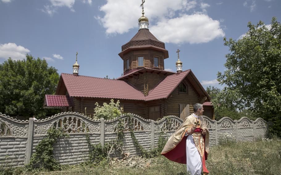 Father Vitalii Kester, outside St. Mykolai the Miracle Worker after a Sunday morning Mass for a handful of parishioners in the eastern Ukrainian village of Kostiantynivka on July 3, 2022.