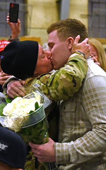 Spc. Maria Cioto reunites with boyfriend, Dan Post, during a a welcome home ceremony for the 3rd Battalion, 197th Field Artillery Regiment on Feb. 8, 2024, at the Manchester, N.H., armory.