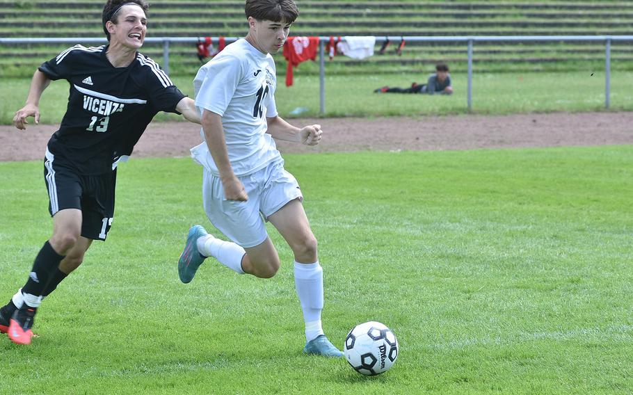 Vicenza's Patrick Blake tries to slow down Naples' Connor Wallace in the DODEA-Europe boys Division II soccer championships in Landstuhl, Germany.