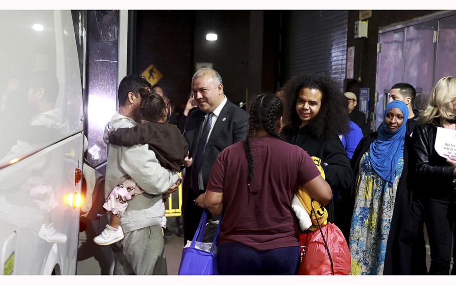 New York City Mayor’s Office of Immigrant Affairs Commissioner Manuel Castro, center, welcomes migrants arriving at the Port Authority Bus Terminal, Wednesday, May 3, 2023. 