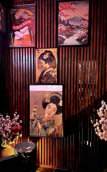 Japanese-influenced art decorates the wall of a restaurant. 