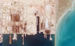 This satellite photo from Planet Labs PBC shows the Iranian Revolutionary Guard's newest ship, the Shahid Mahdavi, center right, under construction in a shipyard west of Bandar Abbas, Iran, Saturday, May 21, 2022. Iran's paramilitary Revolutionary Guard is building the massive new support ship near the strategic Strait of Hormuz as it tries to expand its naval presence in waters vital to international energy supplies and beyond, satellite photos obtained by The Associated Press show. (Planet Labs PBC via AP)