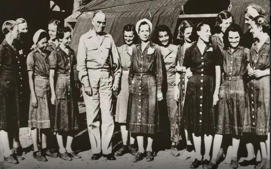 Vice Adm. Thomas C. Kinkaid, Commander, 7th Fleet, poses with the liberated nurses on Leyte on Feb. 23, 1945. Lt. Margaret “Peggy” Nash is in the front row, second from right.