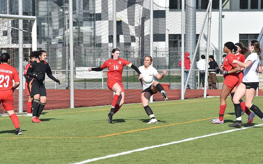 Stuttgart forward Leeba Curlin goes to kick a corner ahead of Raider midfielder Georgia Rawcliffe during a girls soccer match on March 9, 2024, at Kaiserslautern High School in Kaiserslautern, Germany.