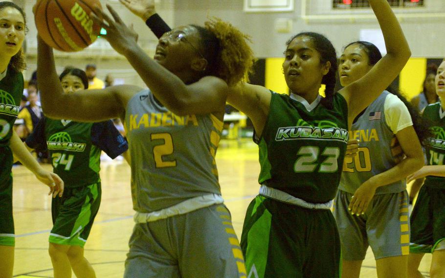 Kadena's Destiny Richardson shoots past Kubasaki's Kadence Johnson during Friday's DODEA-Okinawa girls basketball game. The Panthers won 40-12.