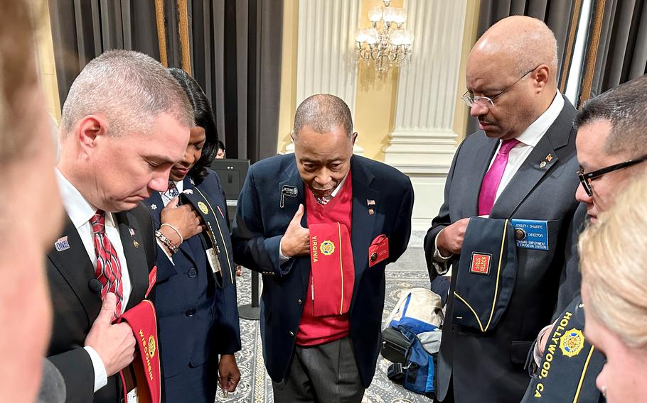 American Legion National Chaplain Frank Carr, center, leads a group in prayer before a joint House and Senate Veterans’ Affairs Committees hearing on Capitol Hill on Wednesday, March 13, 2024.