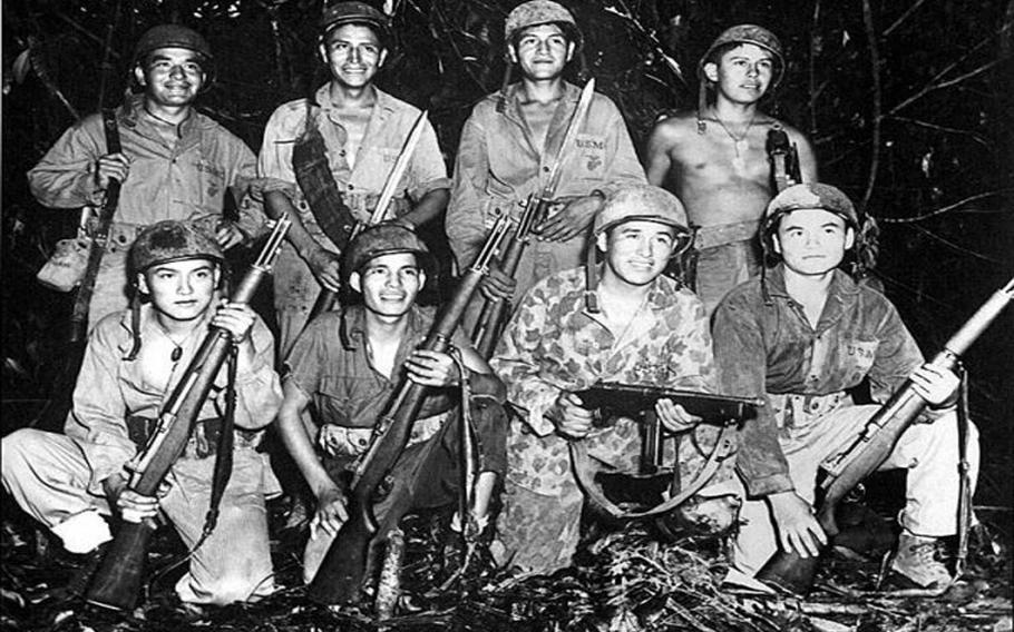 Navy and Marine personnel posing for a photo opportunity during World War II.