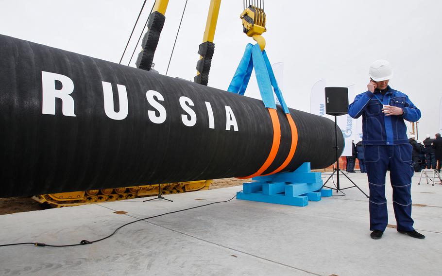 A Russian construction worker speaks on a mobile phone during a ceremony marking the start of Nord Stream pipeline construction in Portovaya Bay some 170 kms (106 miles) north-west from St. Petersburg, Russia on April 9, 2010.