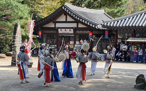 Visitors watch a performance at the Korean Folk Village in the Gyeonggi province, South Korea.