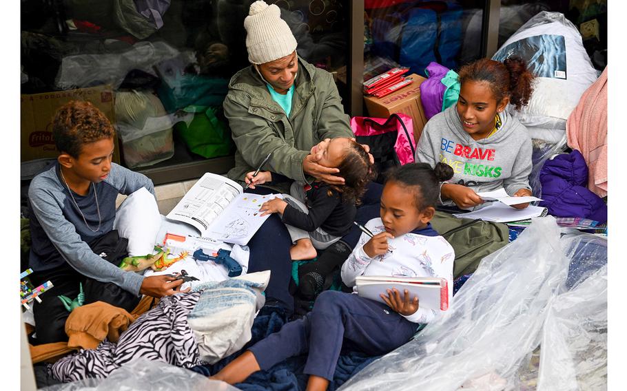 Marioxi Leon sits with her four children. 