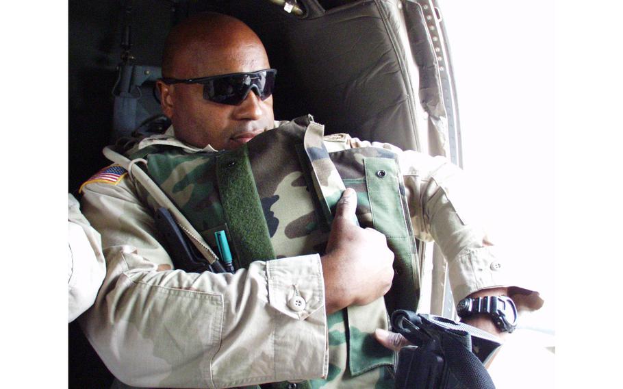 Master Sgt. Curtis Curry gets ready for an aerial vehicle check from inside a Black Hawk helicopter.