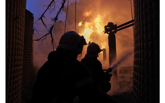 Firefighters attempt to extinguish a blaze at an electricity facility after a Russian attack in Kharkiv, Ukraine, on March 22, 2024.