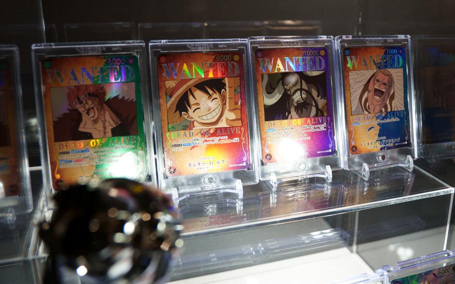 “One Piece” game cards are displayed in a shop.