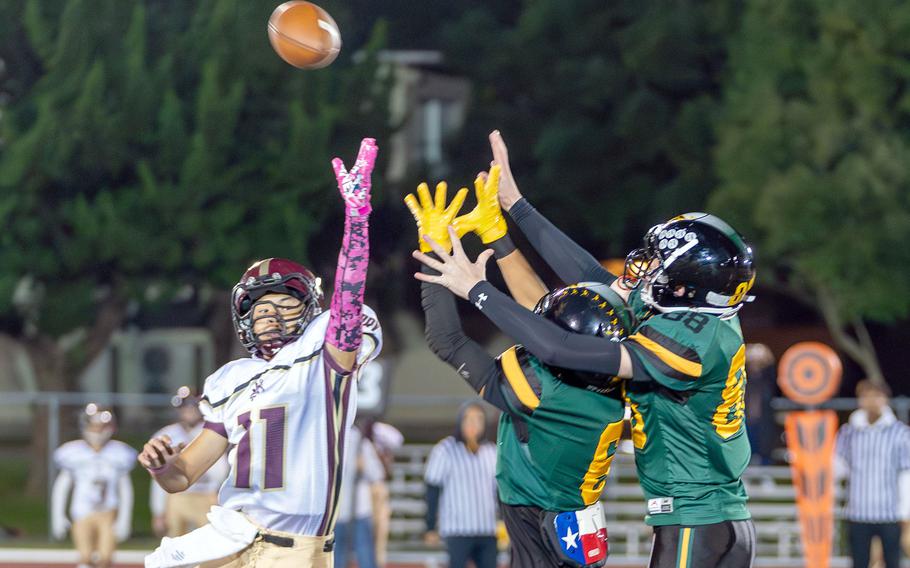 Matthew C. Perry's Kameron Ramos and Robert D. Edgren's P.J. Lorenzo and Roman Wells go up for the ball.