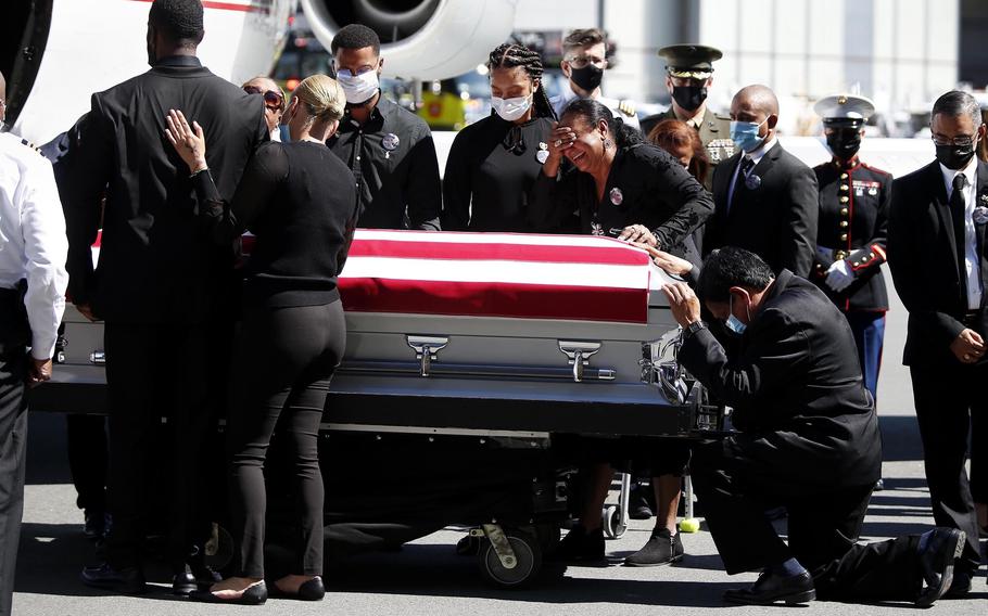 Family members of U.S. Marine Sgt. Johanny Rosario Pichardo are emotional as the casket with Pichardo arrives at Logan Airport on Saturday, Sept. 11, 2021.