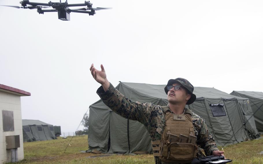 A Marine launches a Skydio X2D unmanned aircraft system.