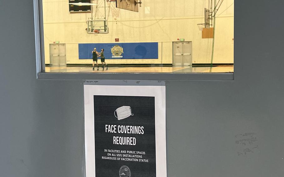 A sign reminds service members to wear a mask inside the Samurai Fitness Center at Yokota Air Base, Japan, Jan. 14, 2022. 