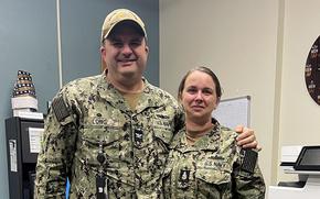 Senior Chief Petty Officer Jessica Saunders poses with Capt. Justin Long, commanding officer of Surface Combat Systems Training Command San Diego. Saunders is the first senior chief gunners mate to be promoted to master chief petty officer in Navy history.