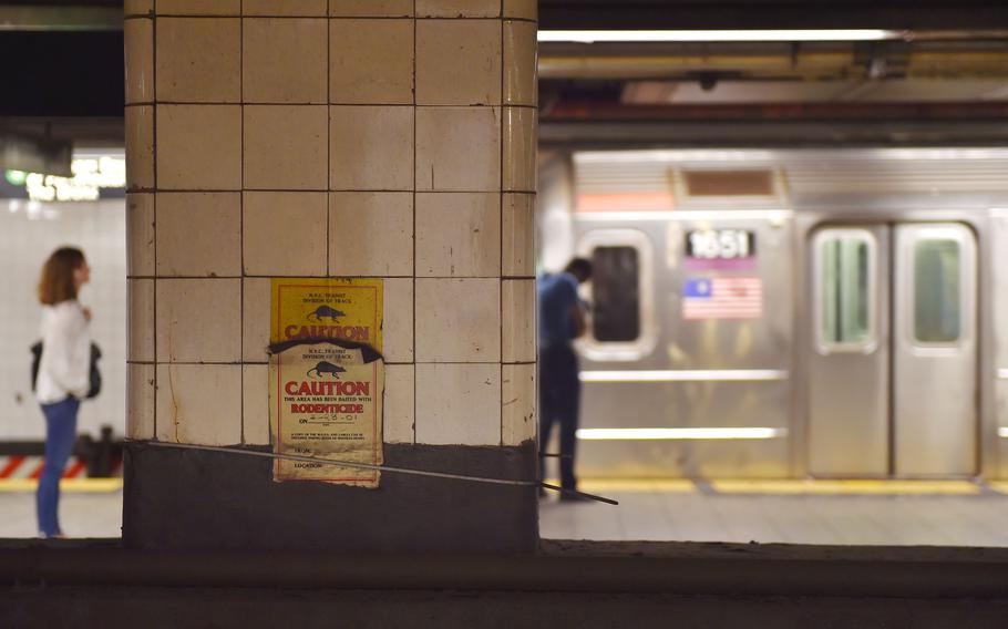 People wait for a train in a subway station, on July 2, 2017 in New York City.