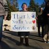 A girl holds a sign welcoming veterans of World War II and the Vietnam and Korean wars outside the National Museum of the Marine Corps in Triangle, Va., on Nov. 2, 2019. Many young veterans are uncomfortable with the phrase thank you for your service, a recent USAA survey found. Most veterans over age 45 said it didn't bother them.