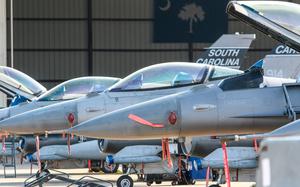 The fronts and pilot seats of several fighter jets.
