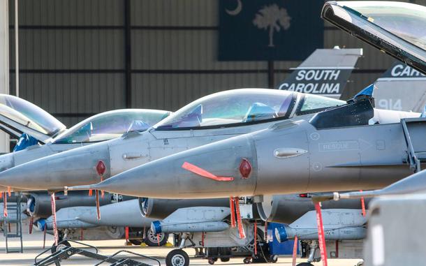 The fronts and pilot seats of several fighter jets.
